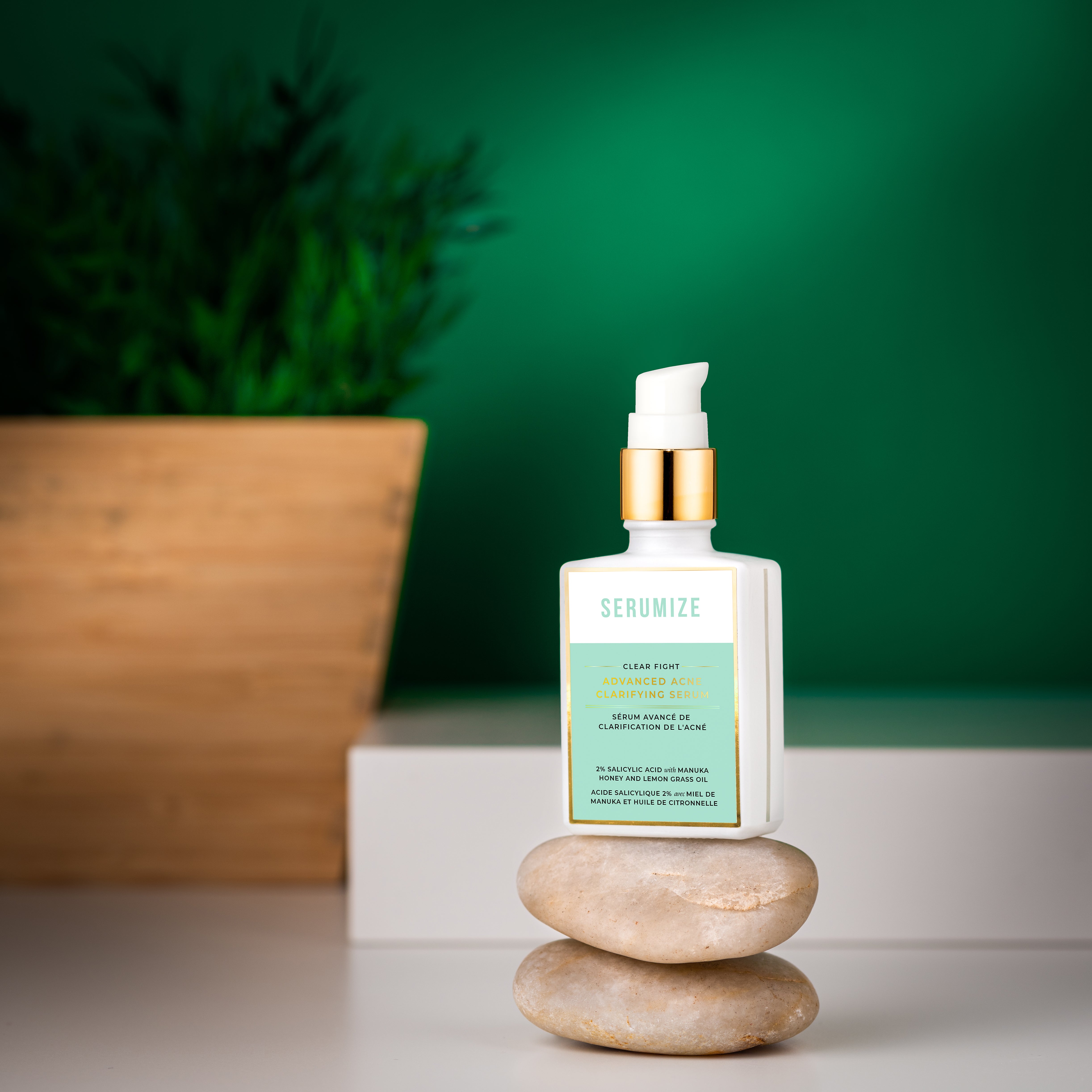 Skincare bottle with green label on a stone surface against a green background